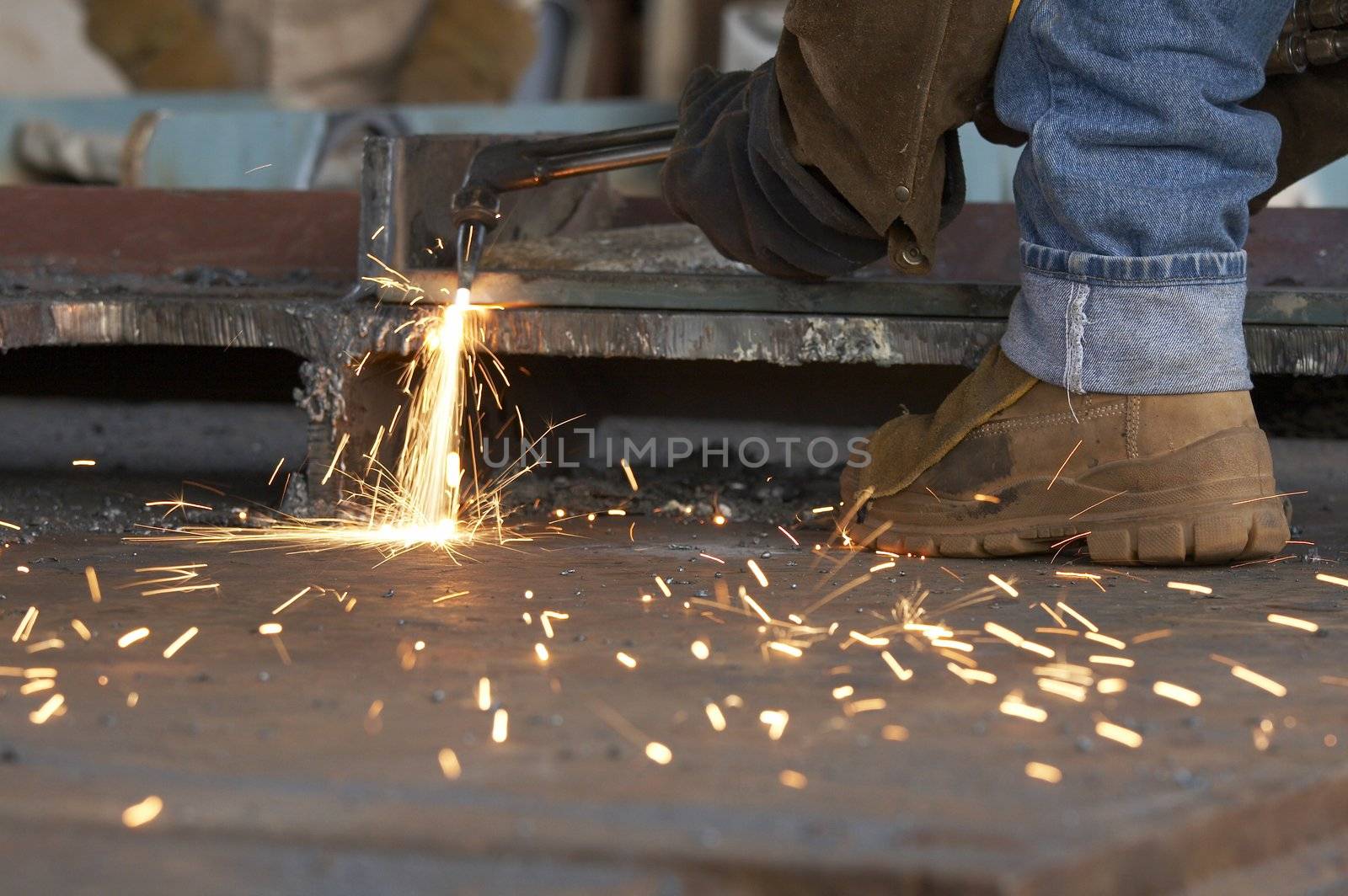 a shipyard steel worker burning steel