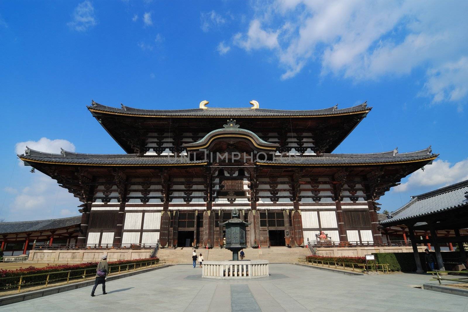 the world biggest wooden building - Todai-ji Temple in Nara, Japan with walking tourists, this building is 49 meters in height and is well-known as the Great Buddha hall