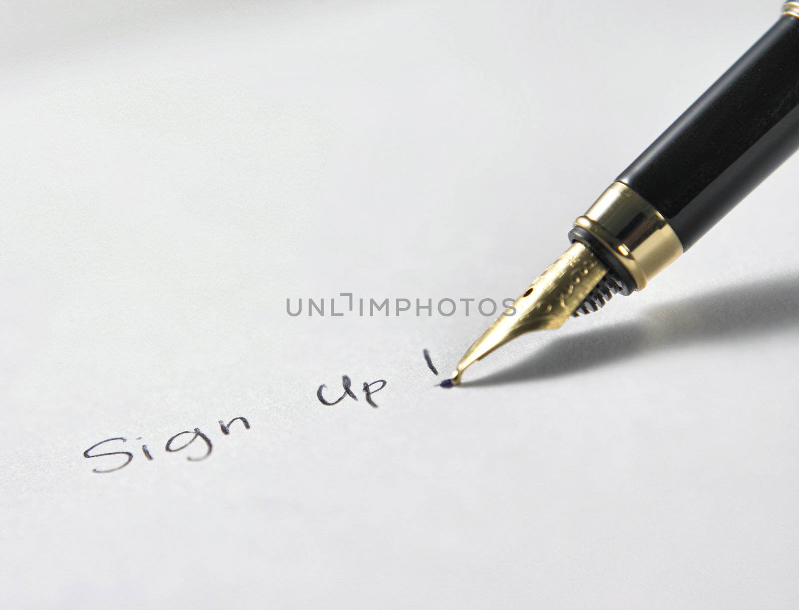 gold color pen writing the paper with text sign up