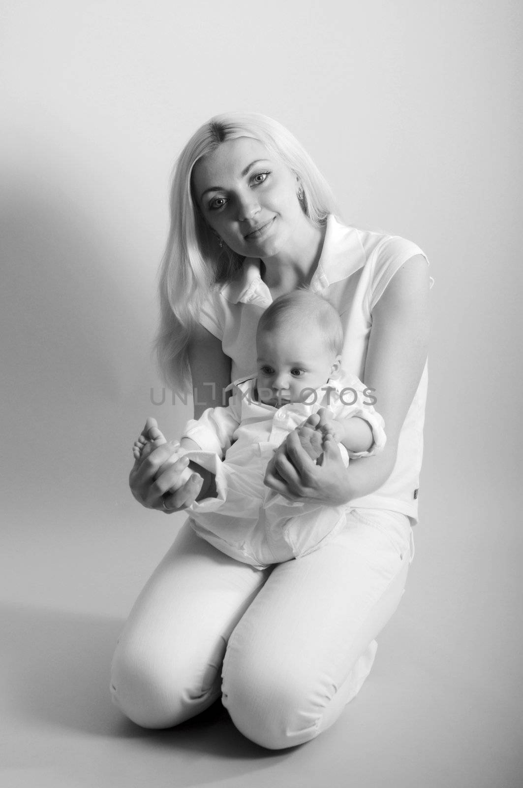 Black and white portrait of happy mother with baby by Mimal