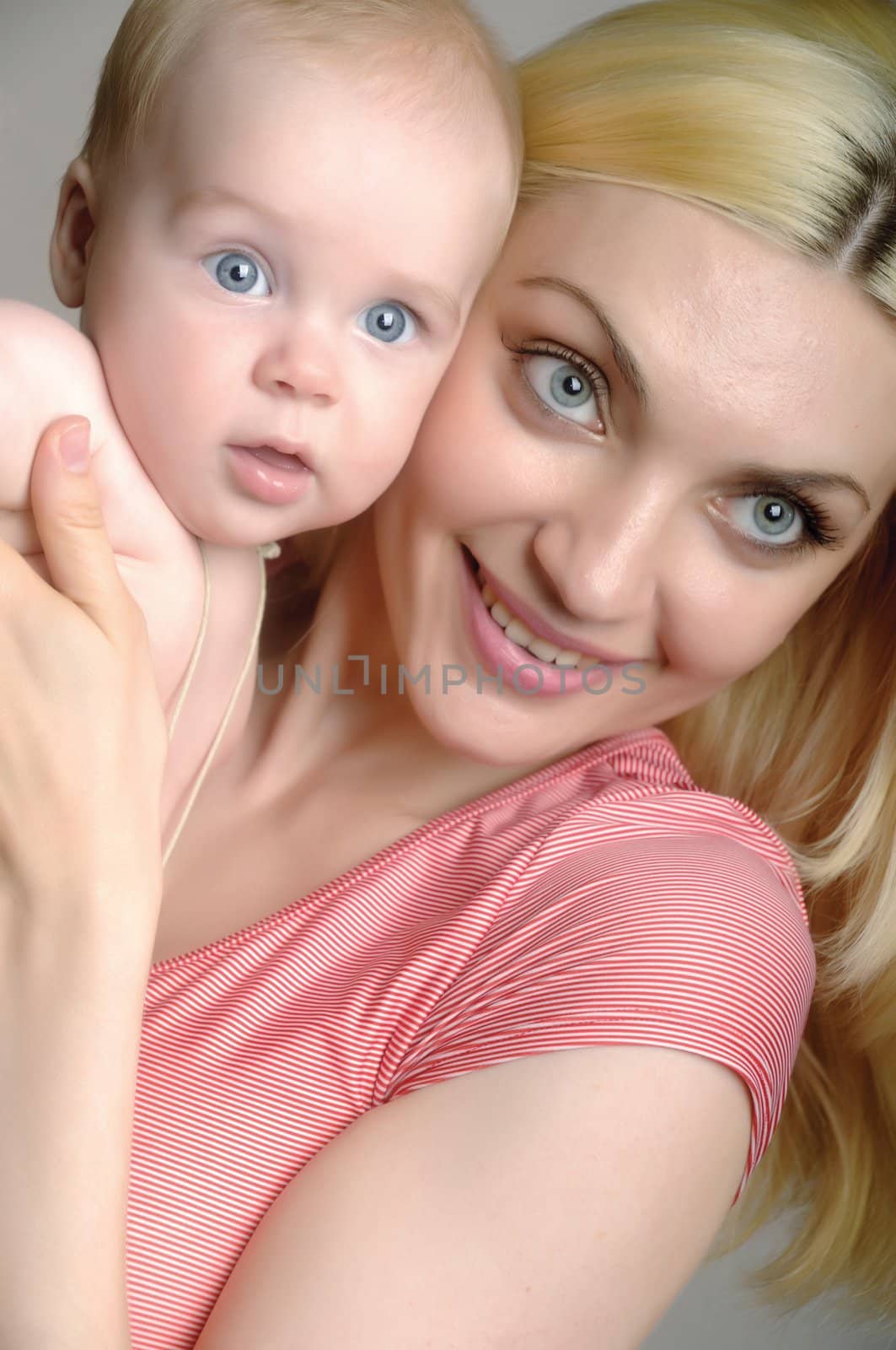 Portrait of happy smiling mother with baby by Mimal