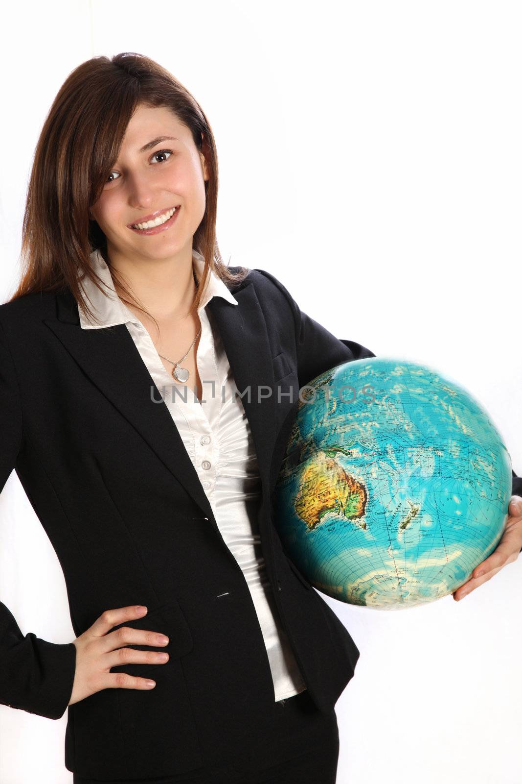 Young woman carrying a globe under his arm. She wears a black suit and smiling.