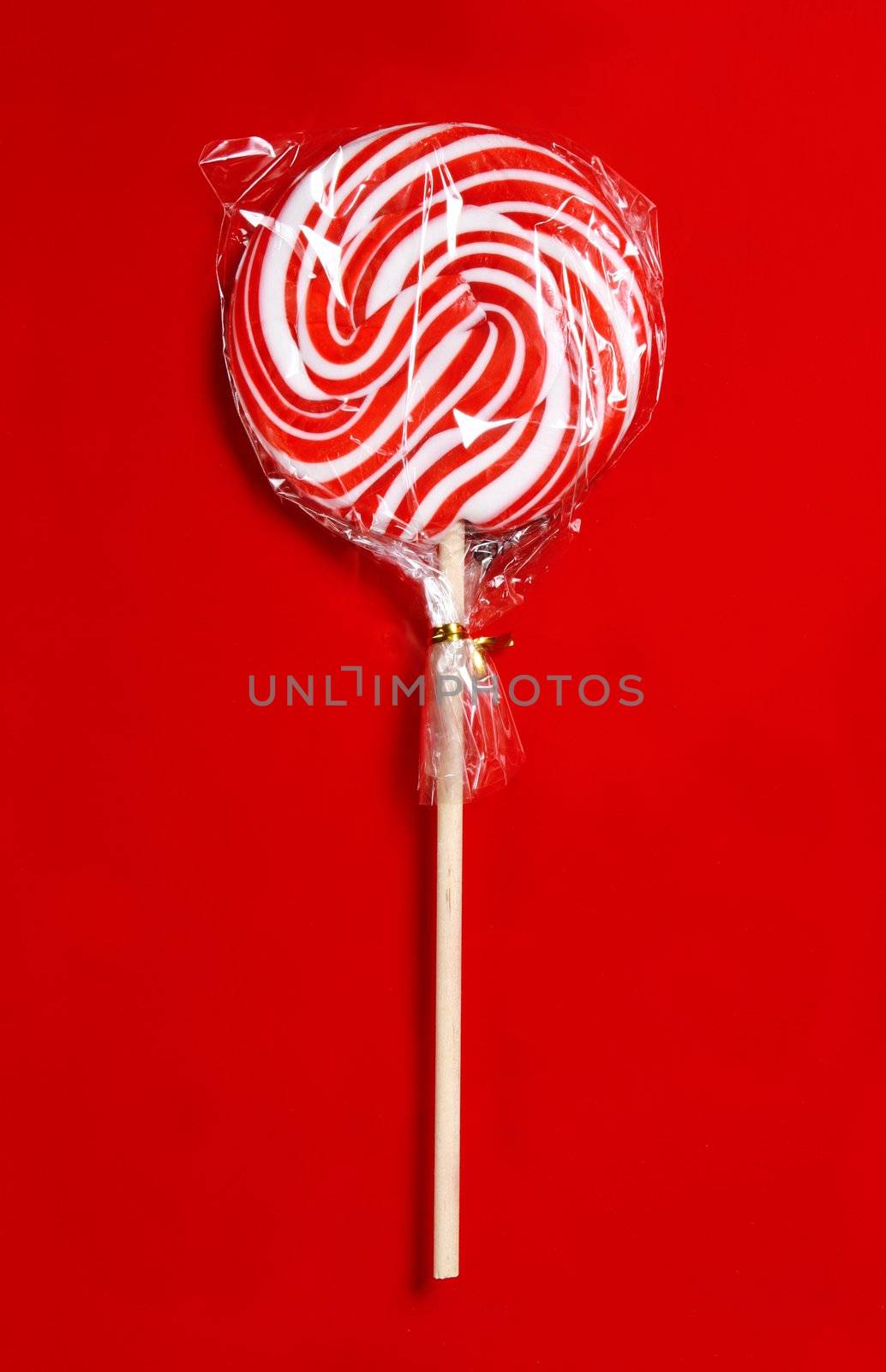 Sweet lollipop isolated on red
