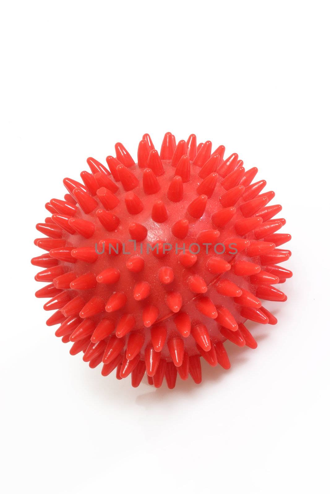 Red massage ball on bright background