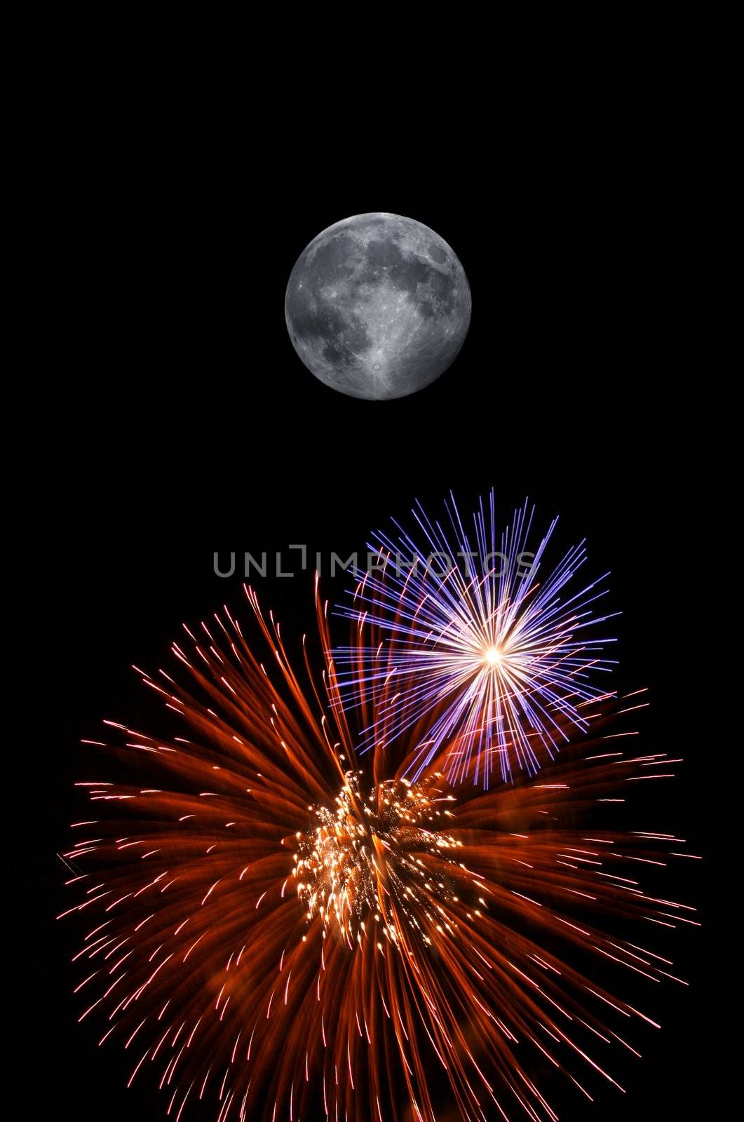 Full moon and fireworks exploding on clear night