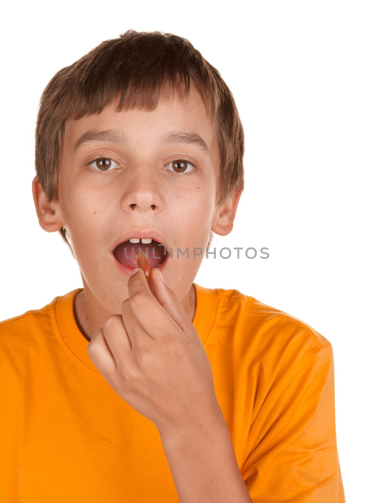 boy taking a pill isolated on white