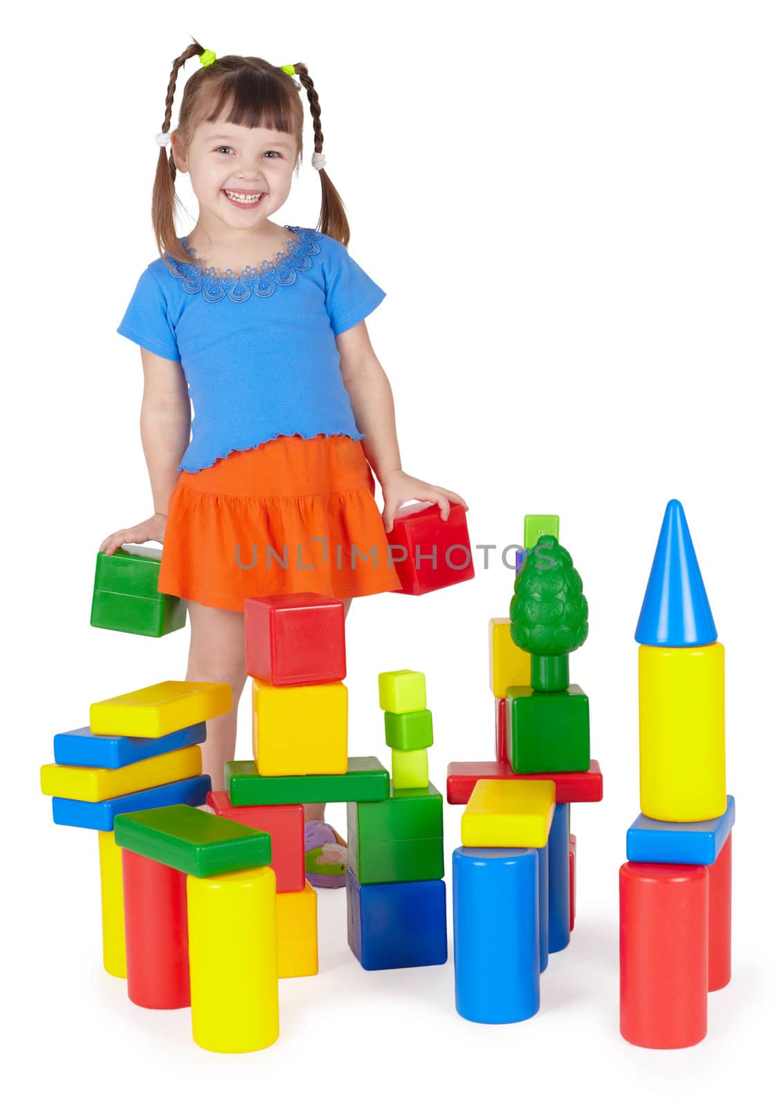 Child happily playing with colored blocks on white