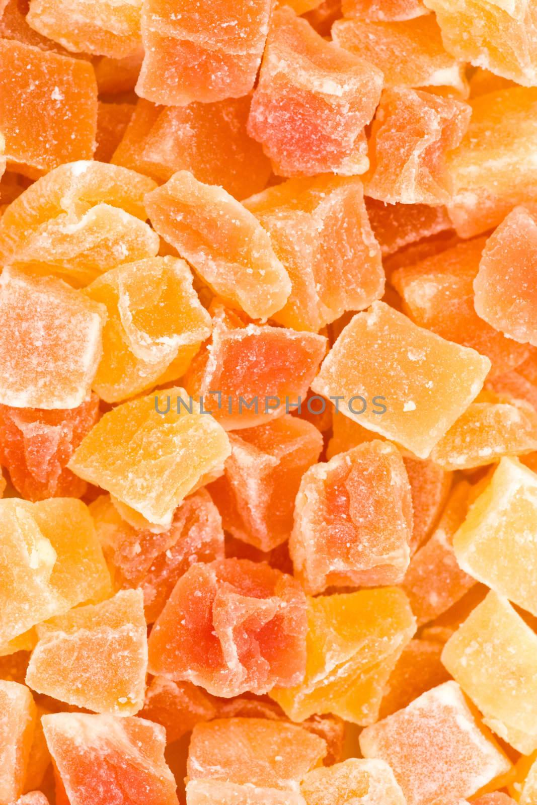 Yellow and orange dried papaya slices background