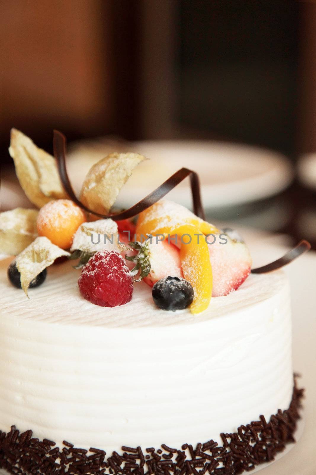 White Cream Icing Cake with Fruits and Chocolate