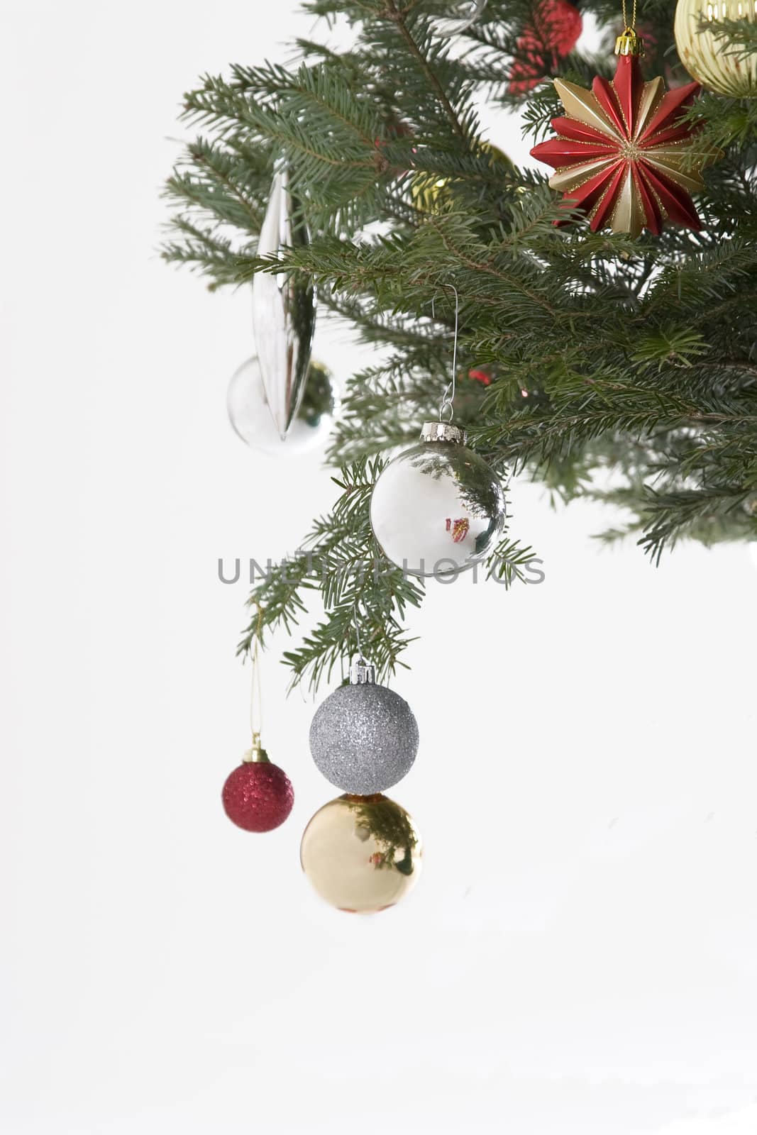 silver, red and gold christmas bulb hanging from the tree