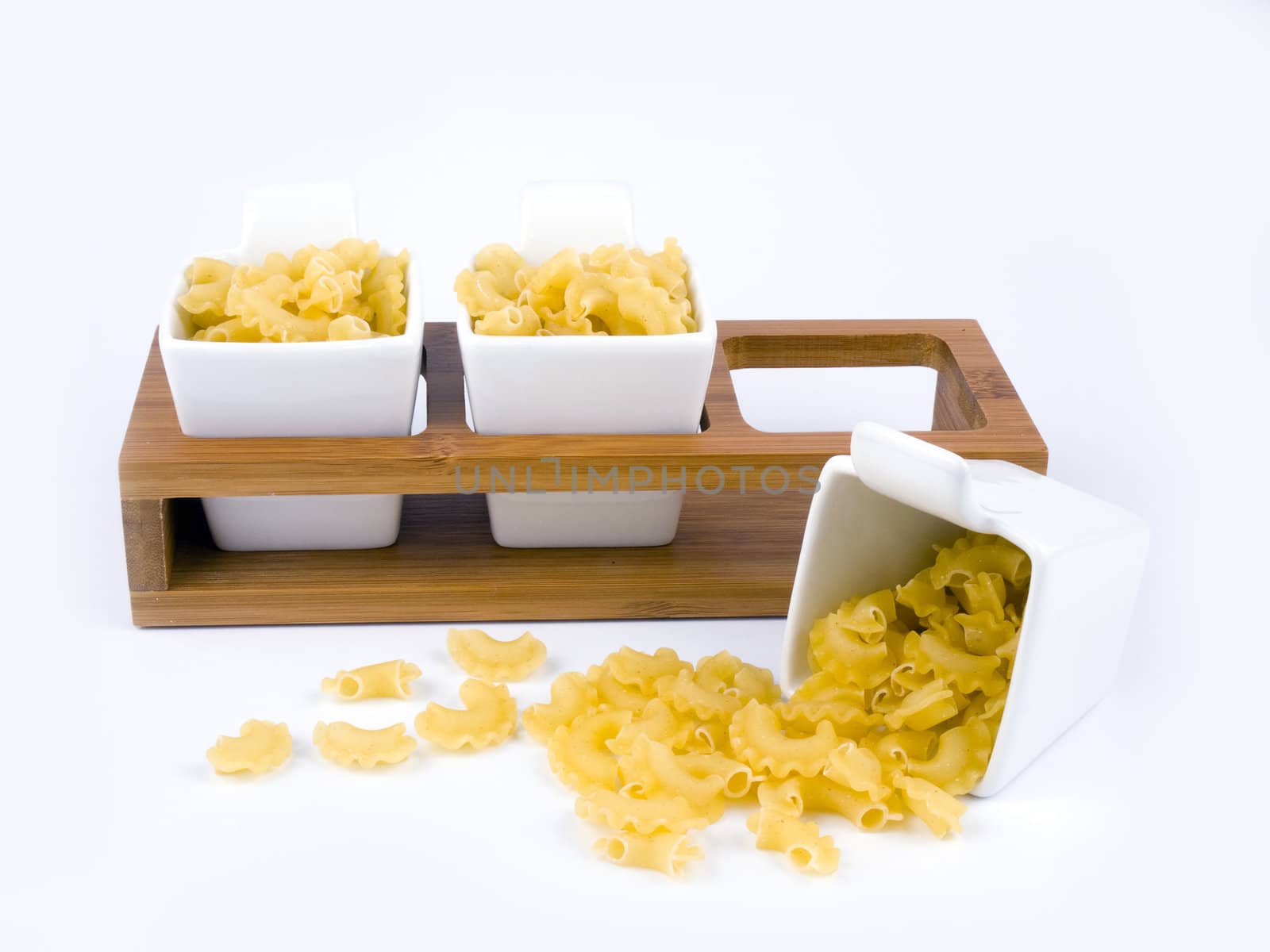 Three porceline bowls filled with pasta on white background