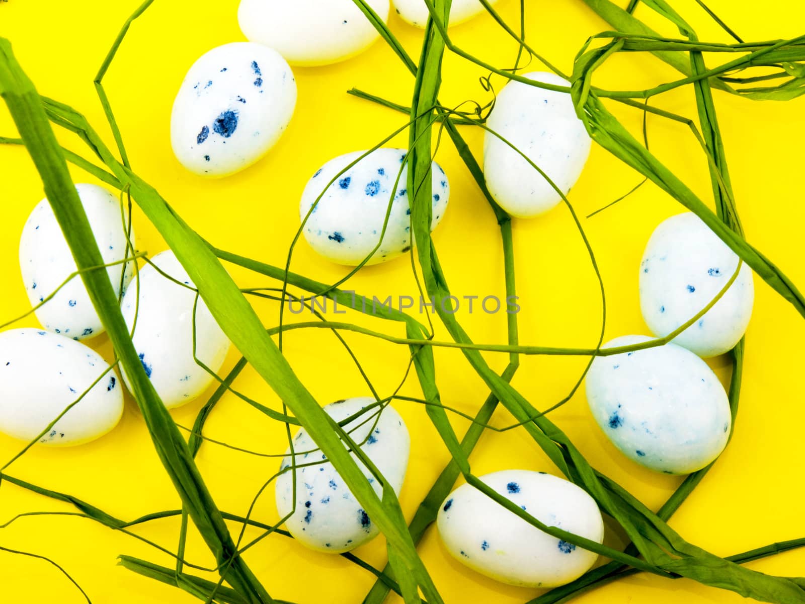 White easter eggs on yellow background.