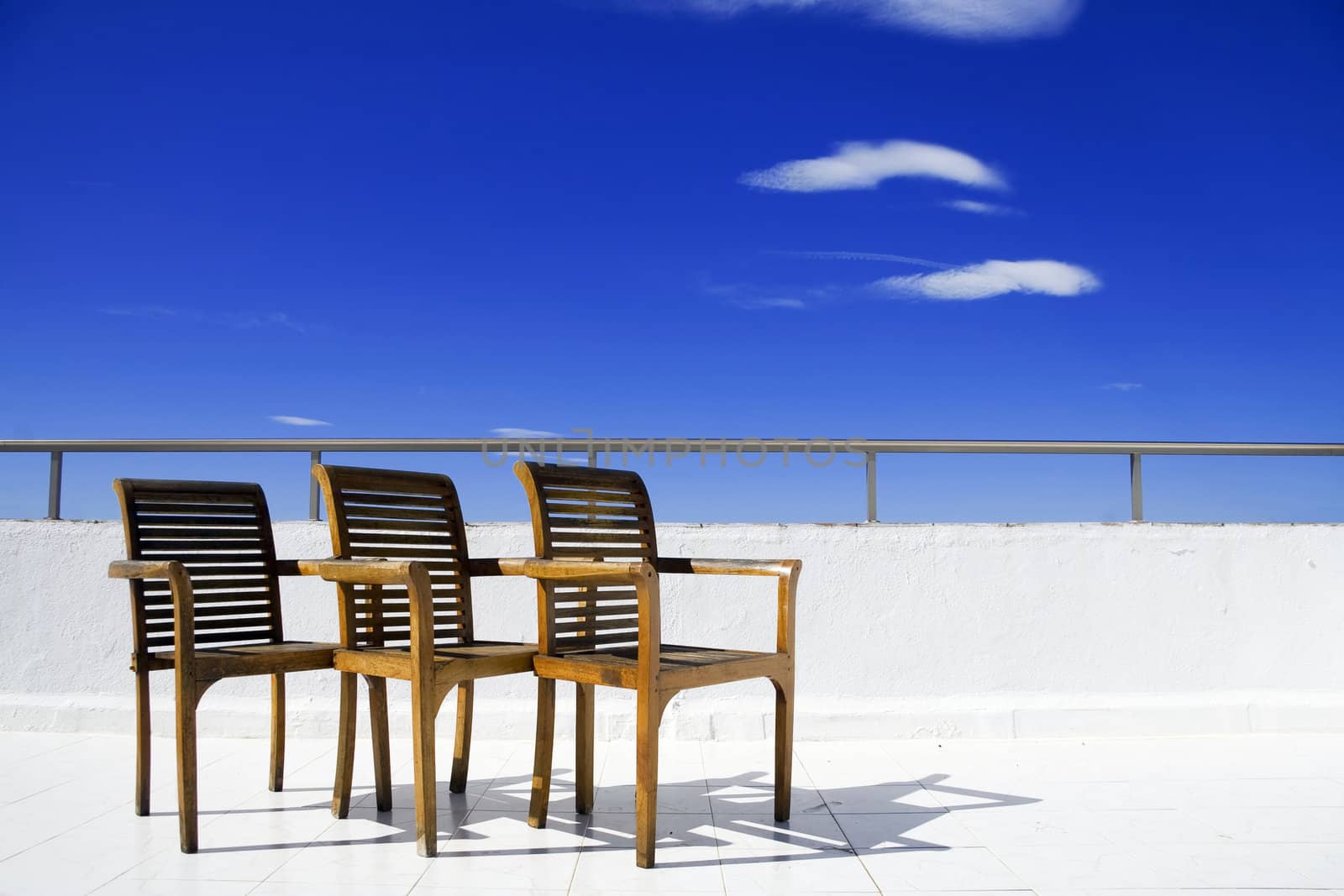 Three chair on balcony by Sazonoff