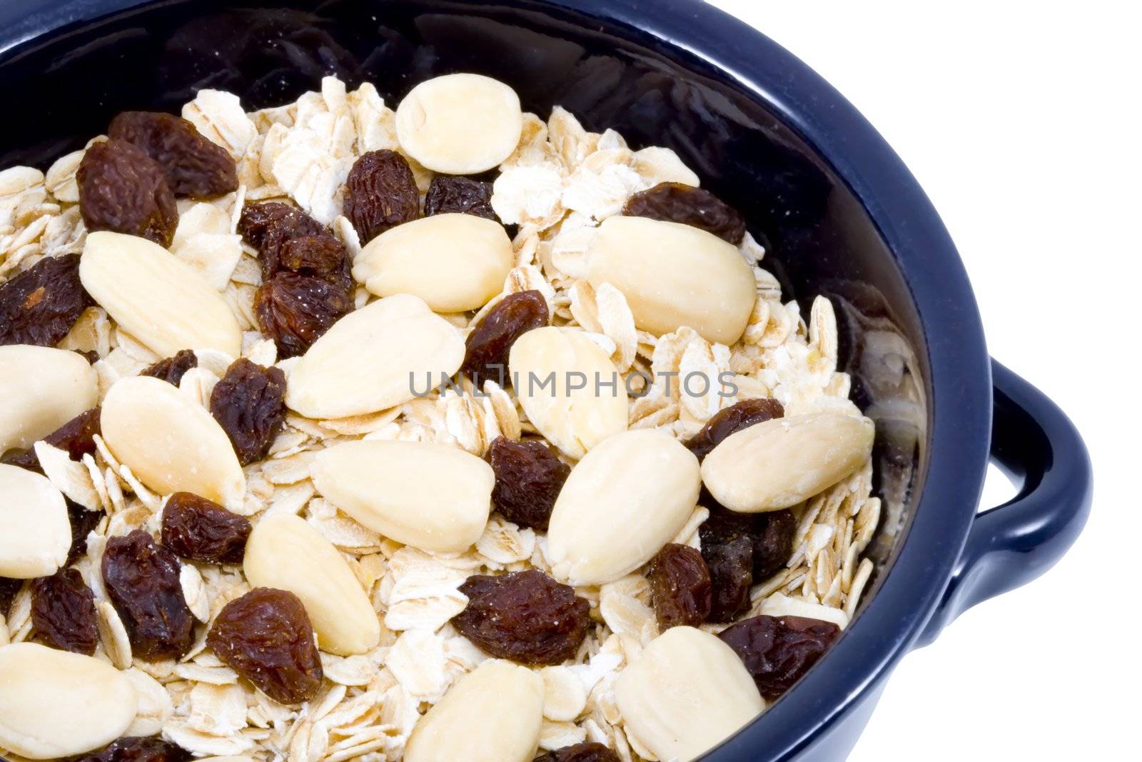 a bowl of oatmeal with raisins and almonds - healthy diet