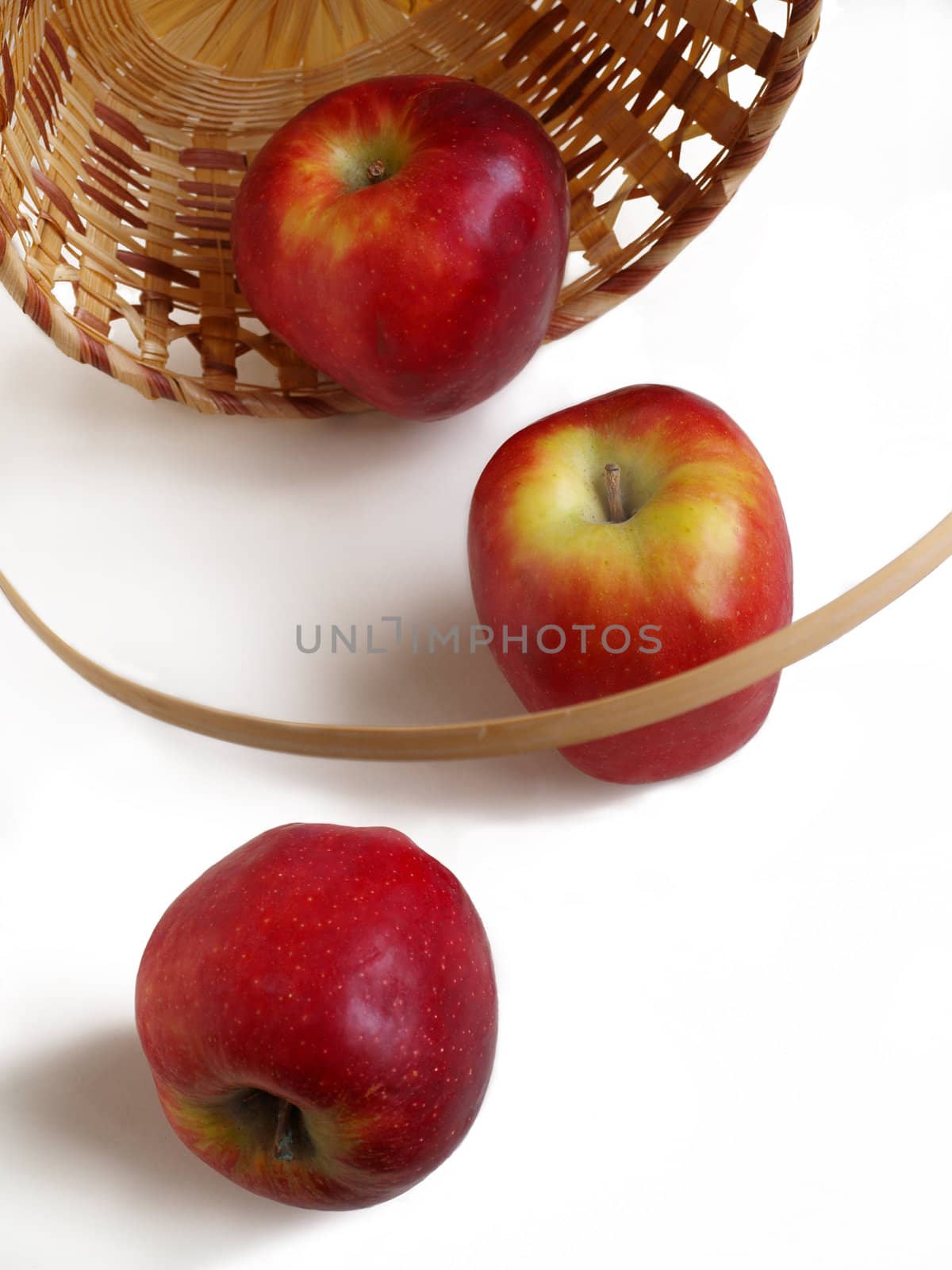 Three apples in a backet on a white background