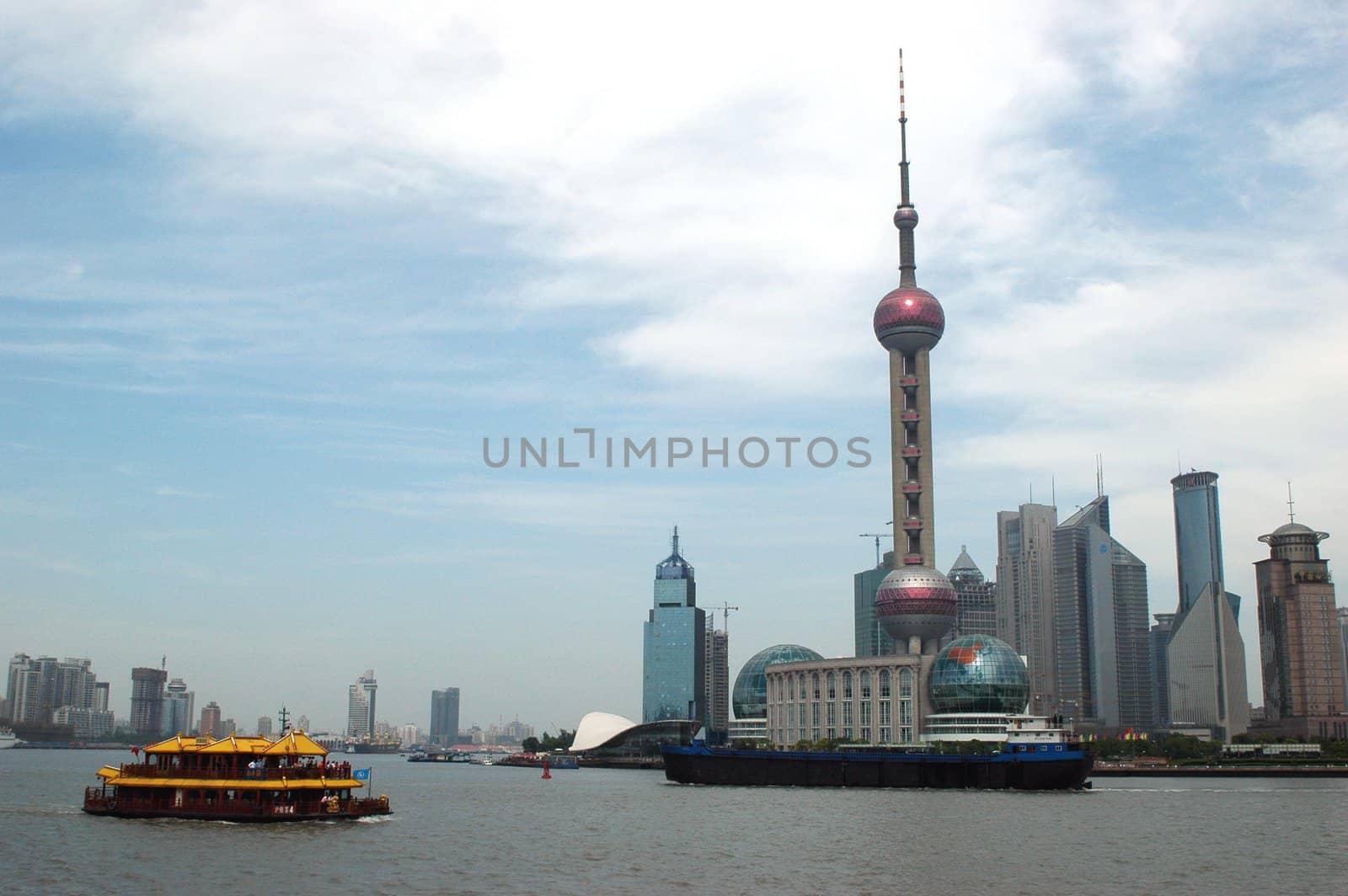 China, Shanghai - general city view, Orient Pearl TV tower, moderns skyscrapers and traditional Chinese ship.