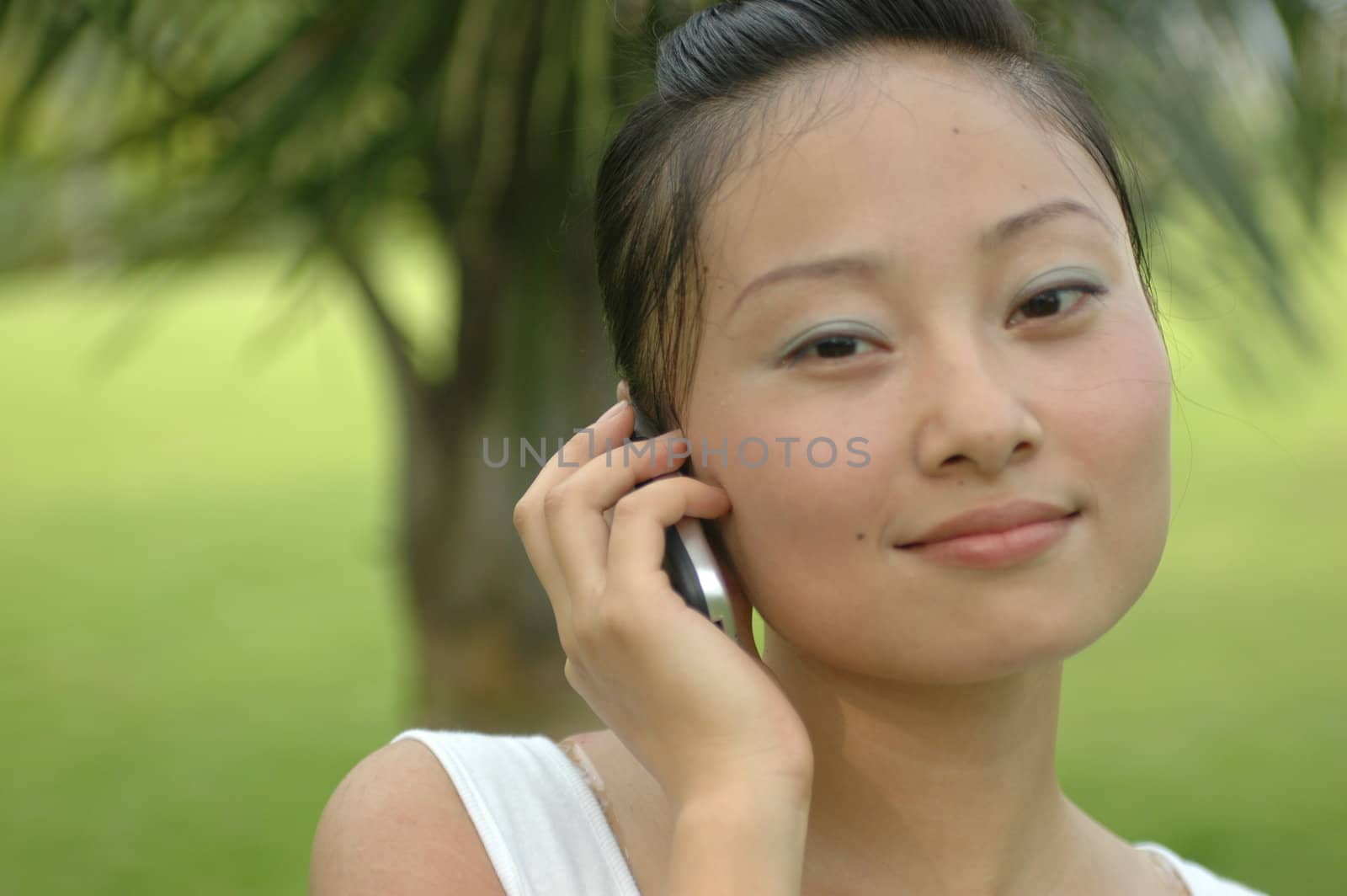 Chinese girl holding cellphone in her hand.