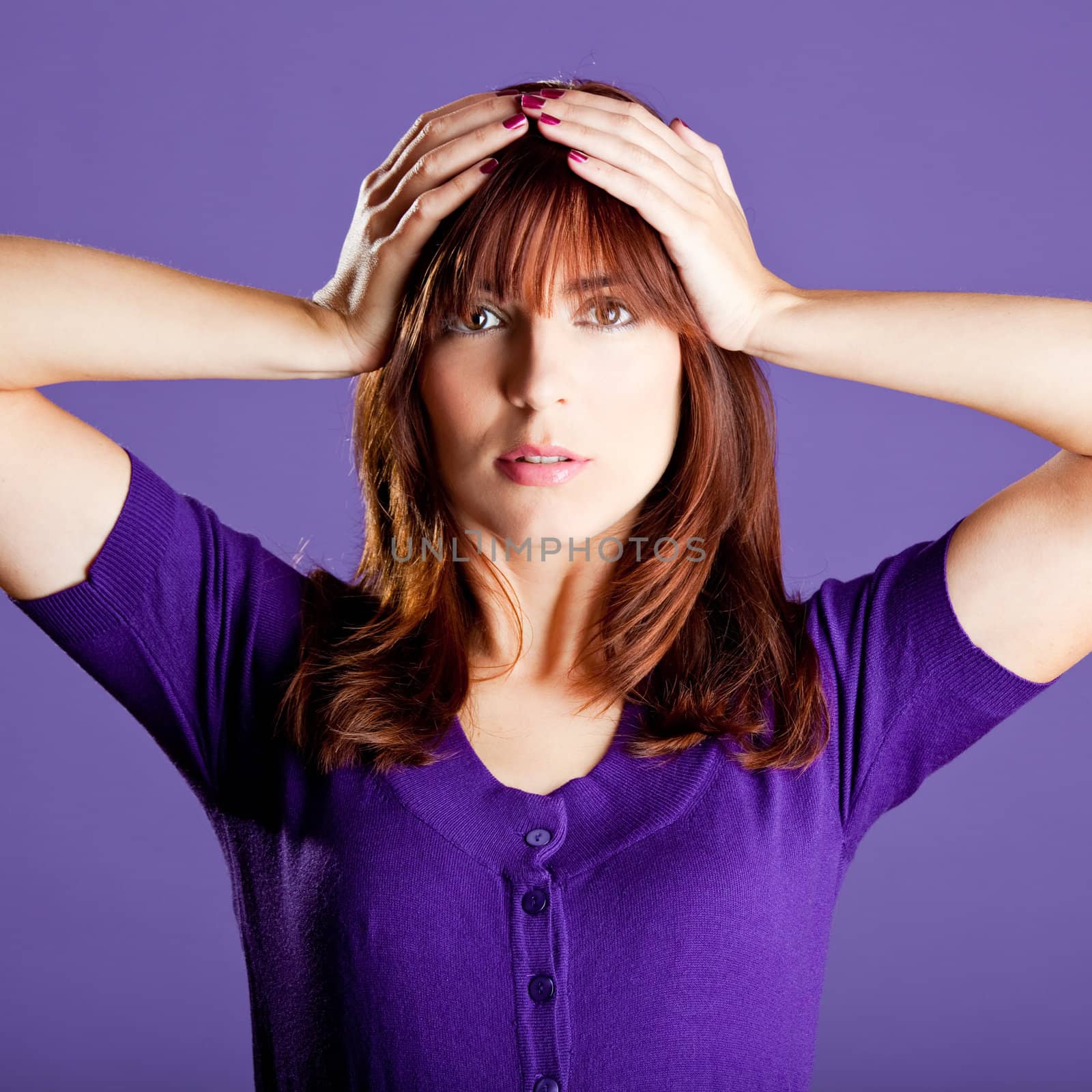 Portrait of a beautiful woman with a worried expression, over a violet background