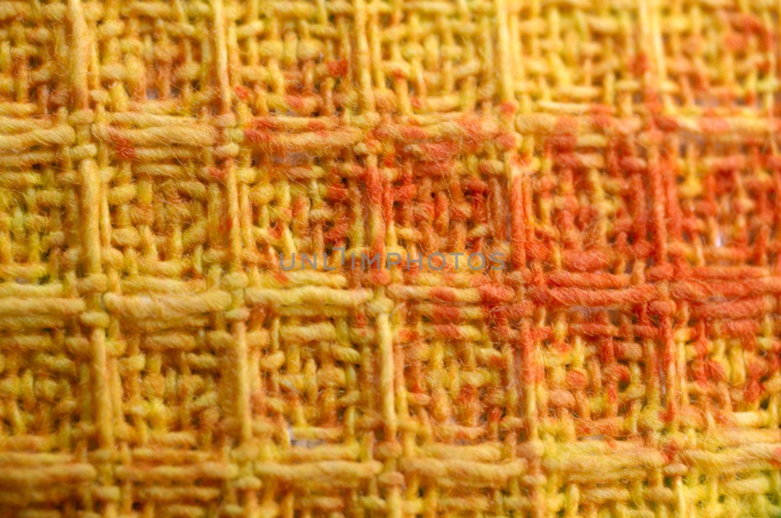 macro pattern of colorful ( yellow, orange, red ) textile fabric