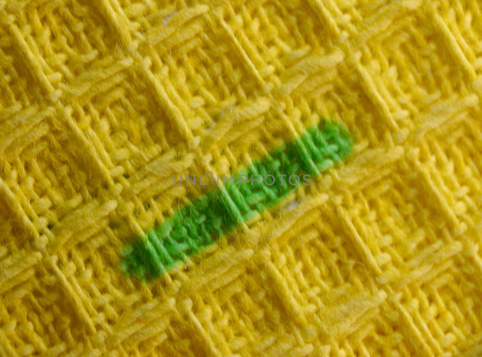 macro pattern of yellow textile fabric with green strip