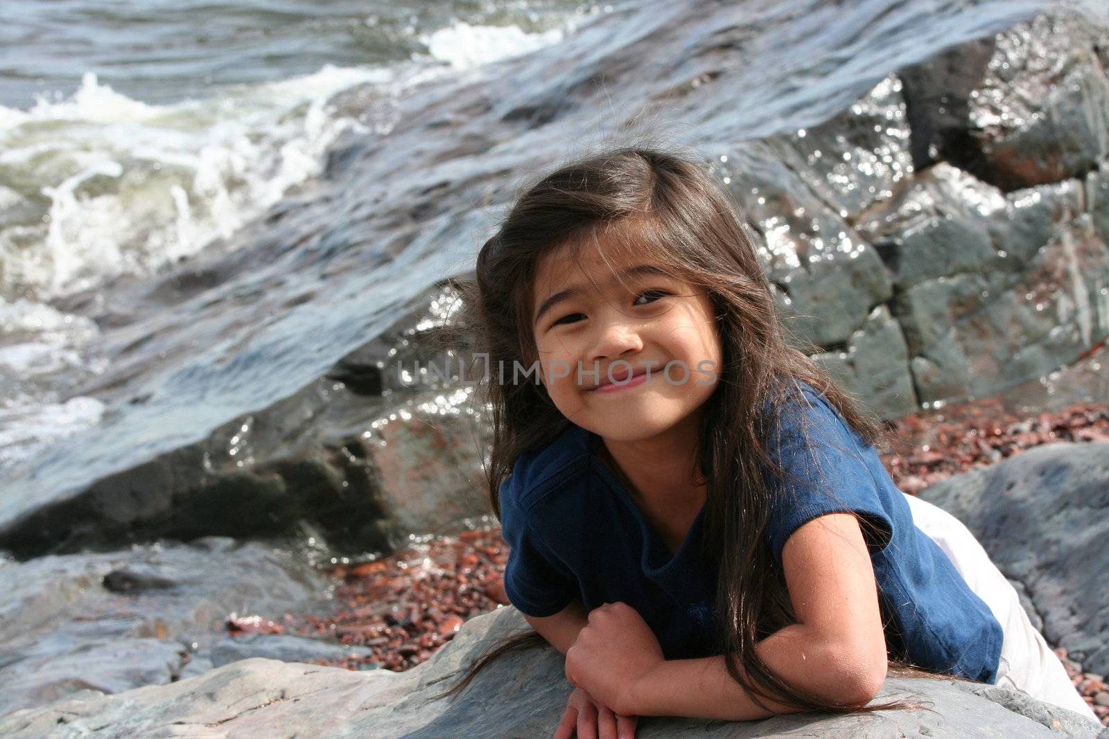 Child playing by lakeshore