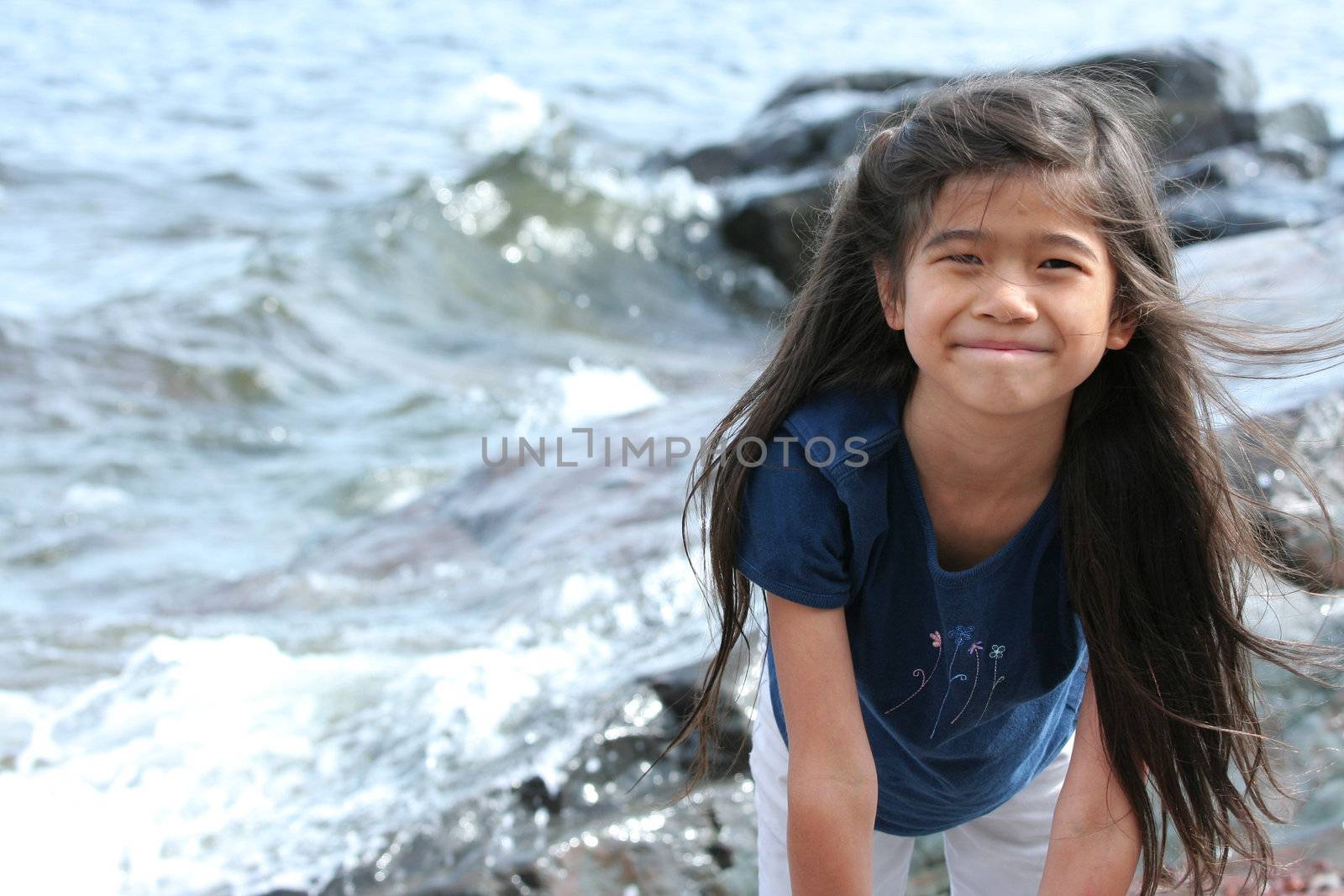 Child playing by lakeshore