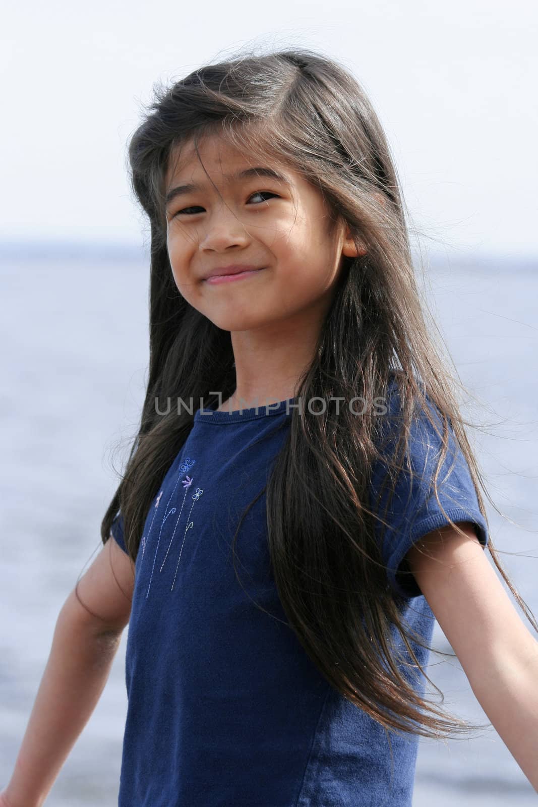 Little girl enjoying the lake shore