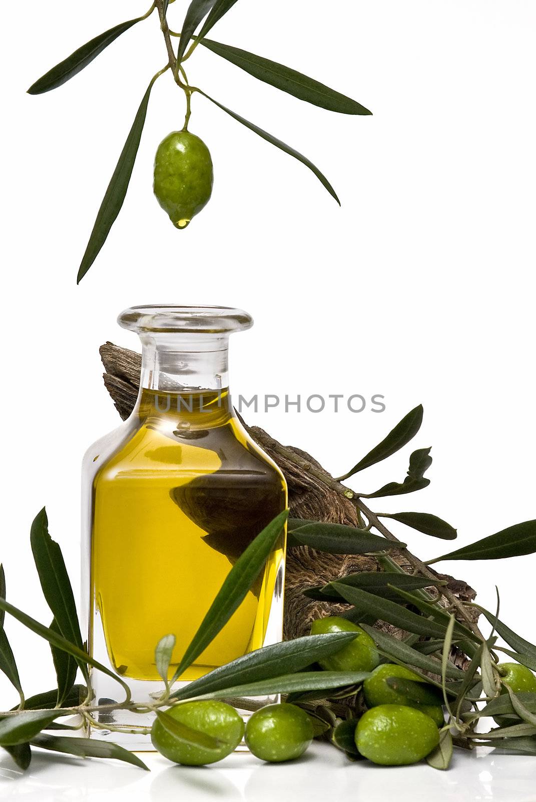 Olive oil bottle witn olives and olive branches isolated on white background.