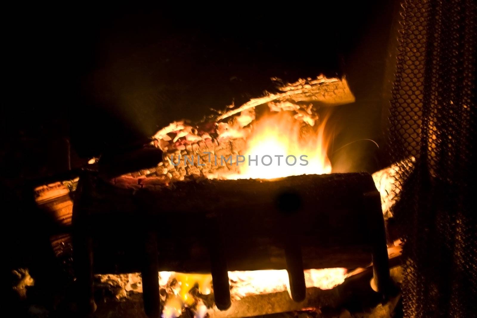 Flames of Fire in a Fireplace against a black Background 