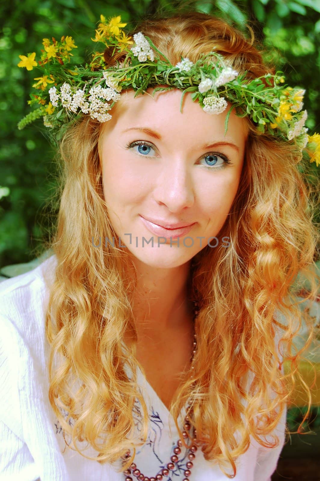 portrait of beautiful sunny redhead girl in flower diadem