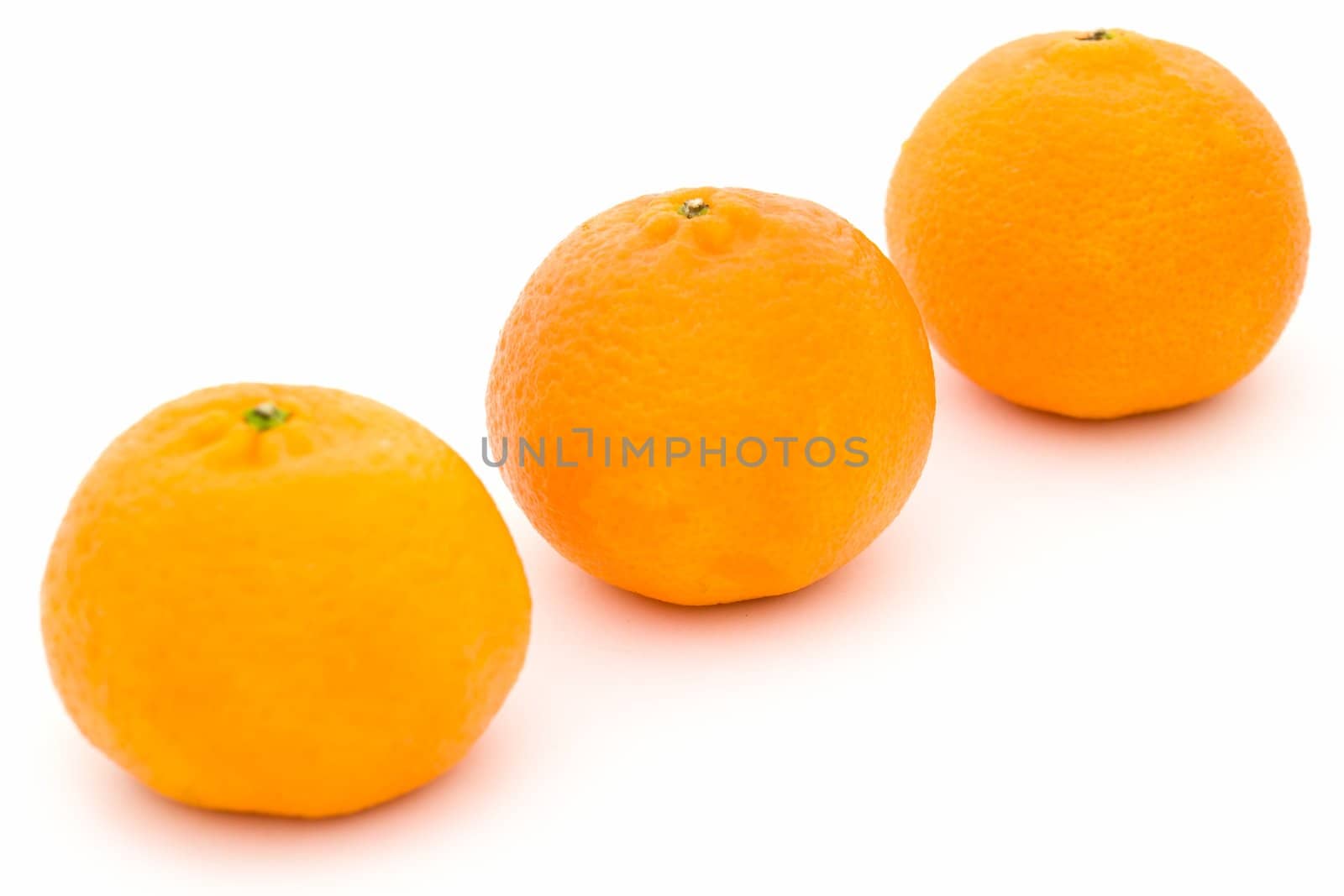 Three big tangerines on a white background