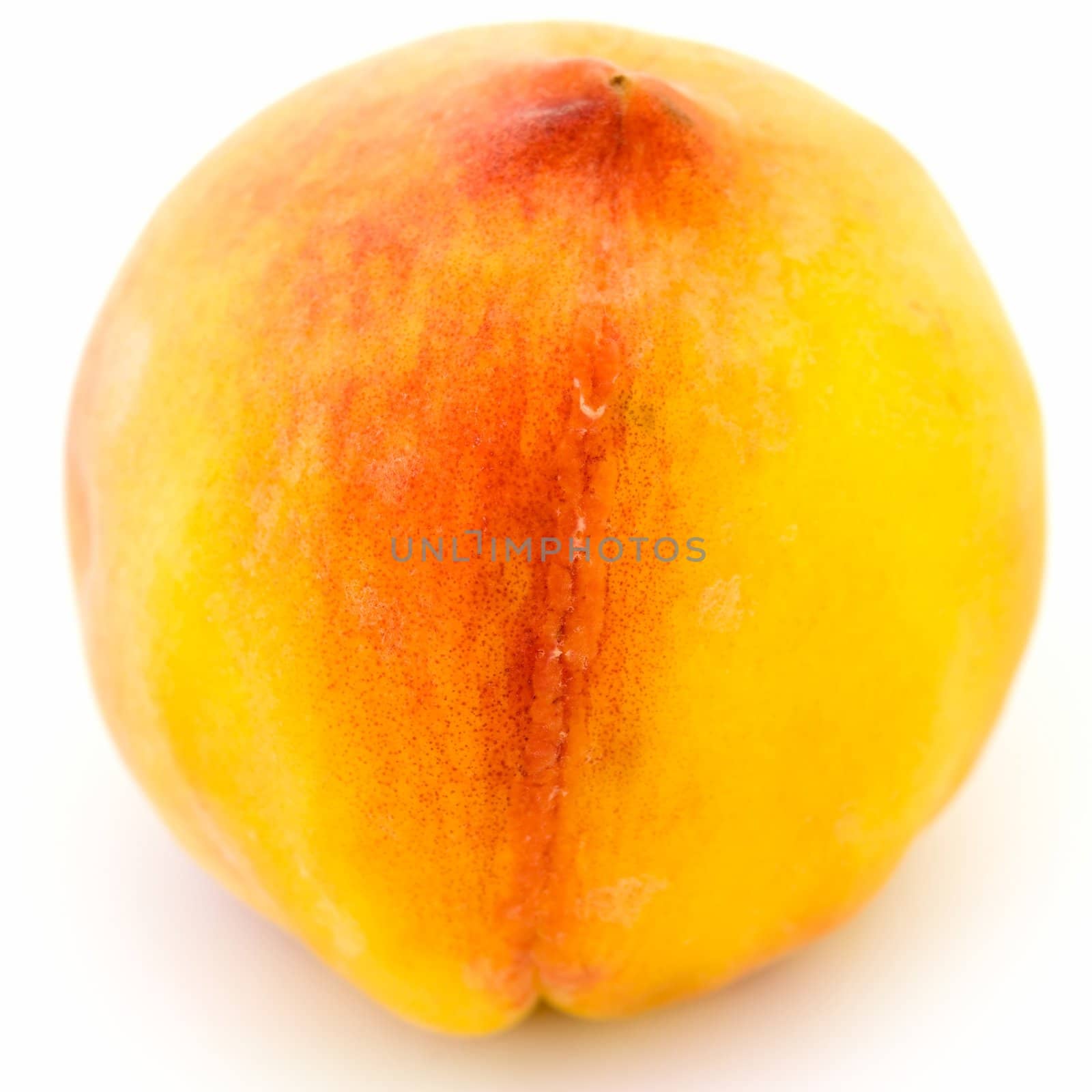 Big ripe peach on a white background