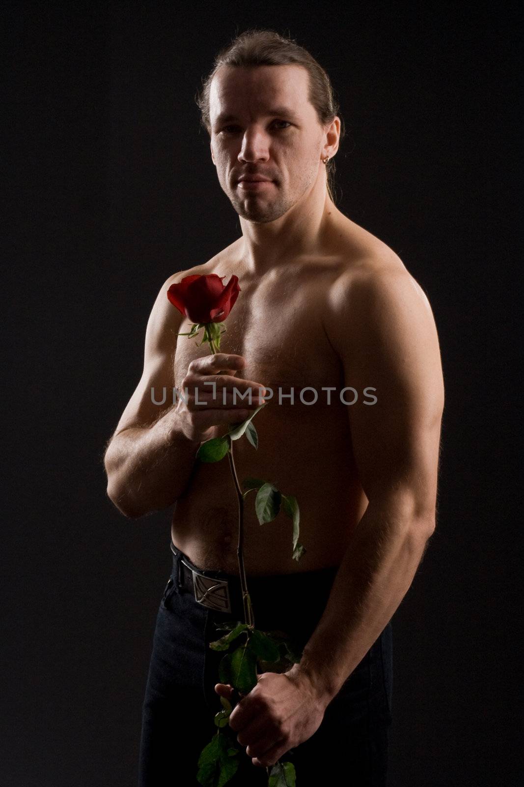 standing romantic man with red rose
