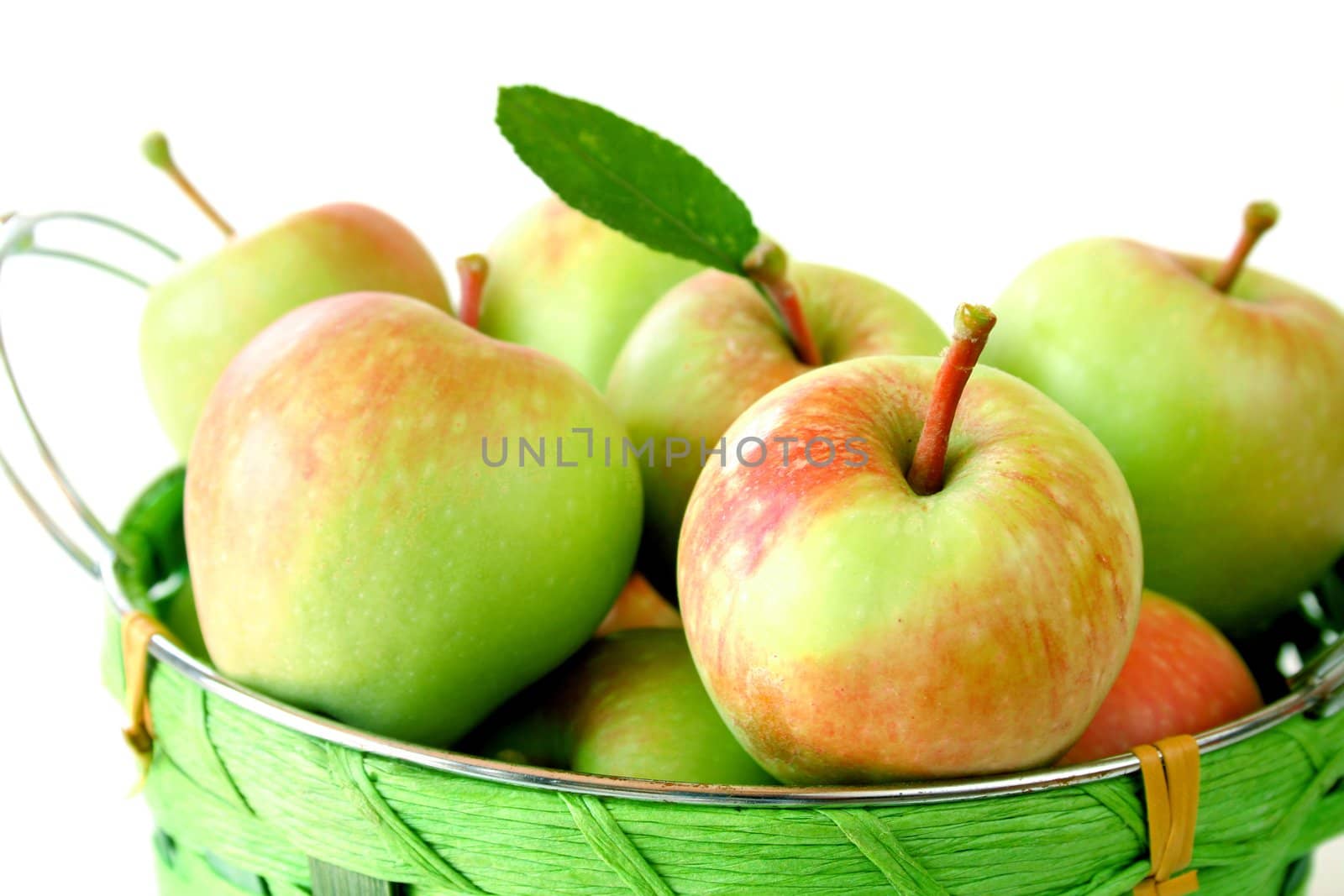 Close up of a basket of apples isolated on a white background.