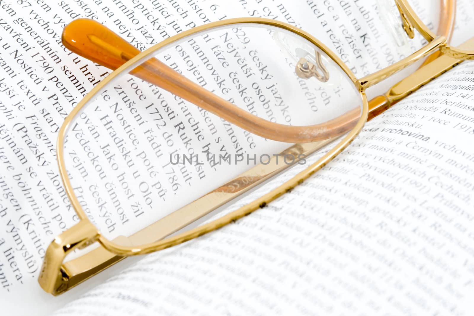 glasses lying on an open book - close up