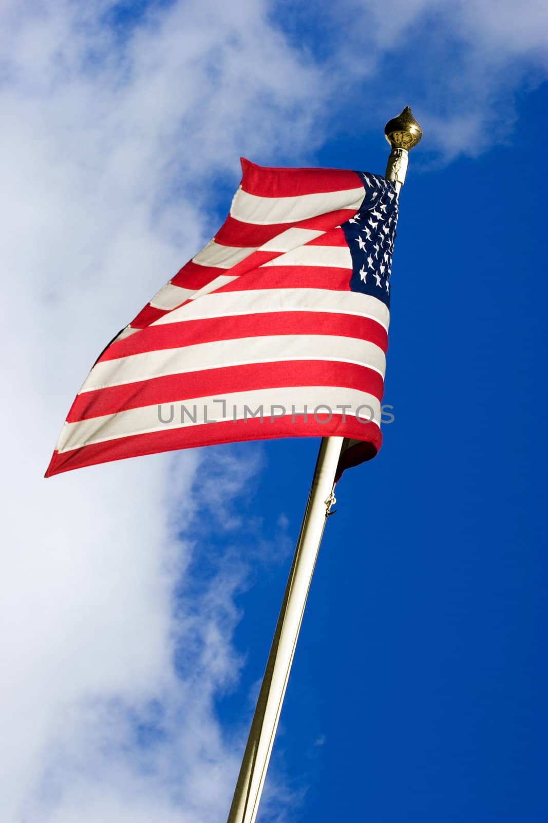 American flag flying in the wind. Clipping path included for easy background replace.