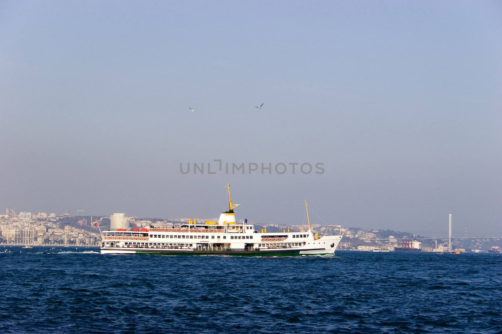 Passenger ferry sails between two continents, Europe and Asia in Bosporus Strait, Istanbul, Turkey