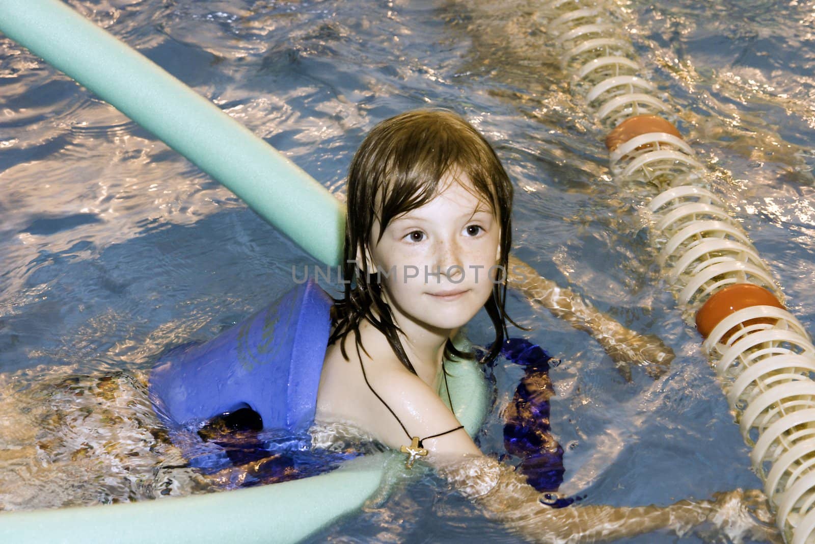 The girl, floats in pool with a life buoy