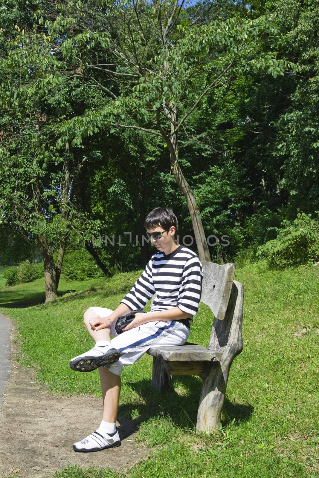 An young man sitting on a bench