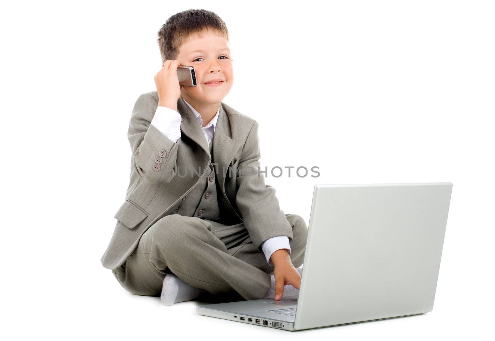 Little kid - businessman sitting with a laptop