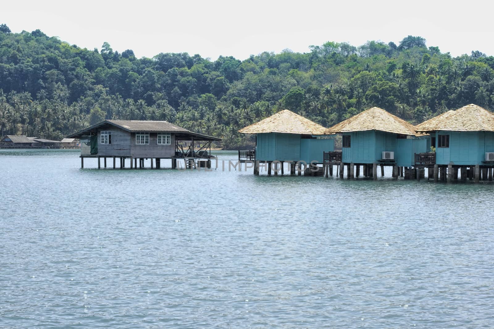 Blue huts in water off island coast