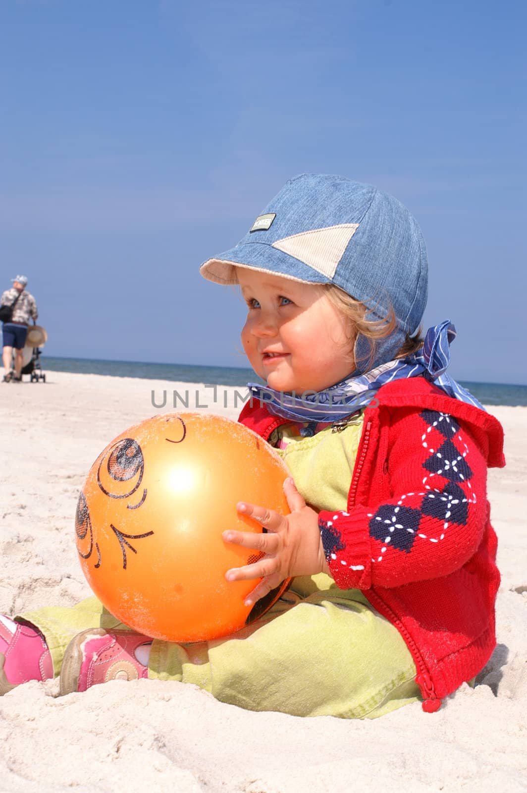 Baby girl and orange ball