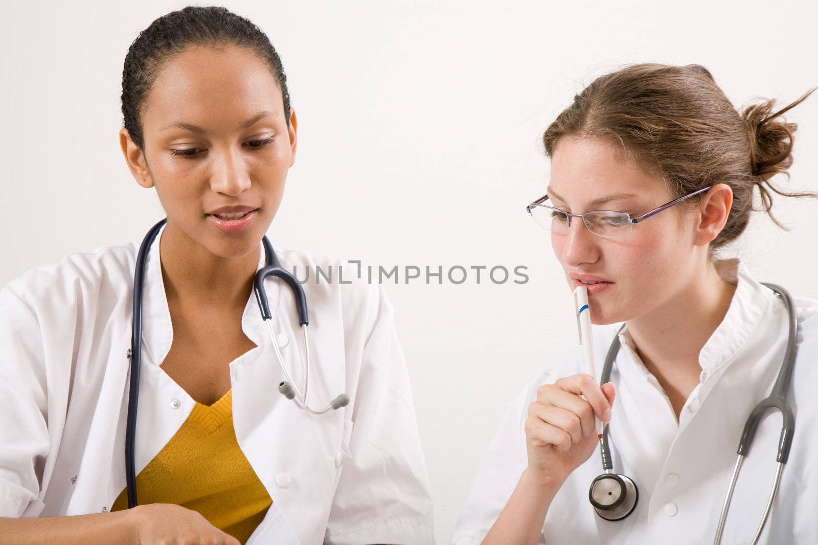 Two medical students discussing something together in the office