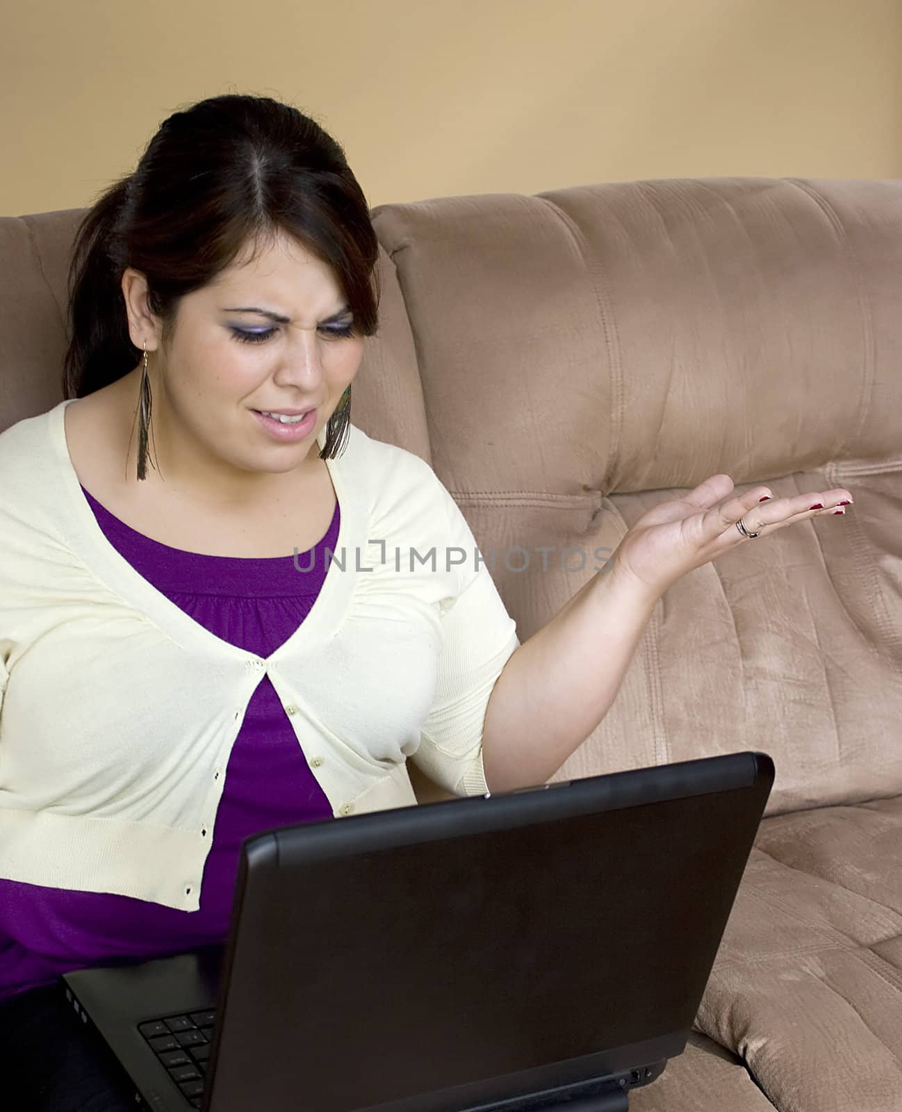 An attractive young woman working on her laptop at home.