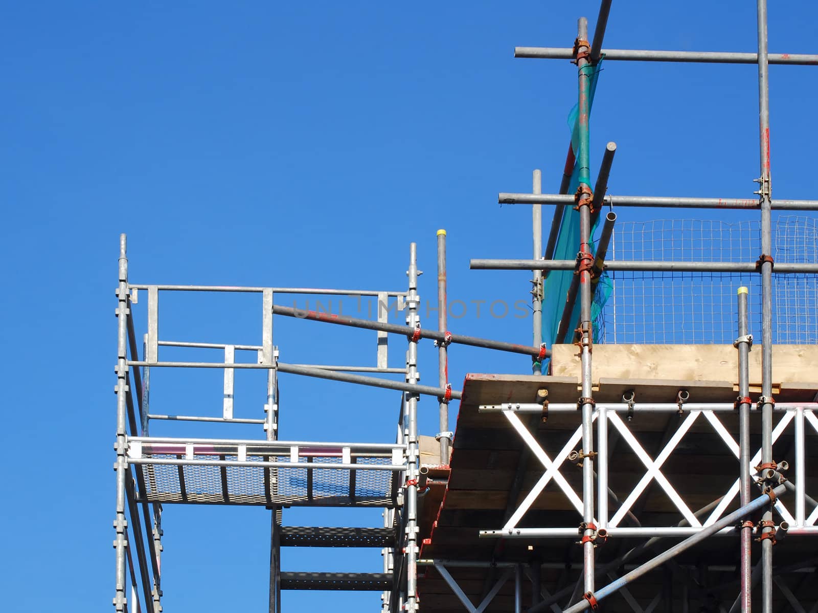 View of scaffolding tower against blue cloudless sky