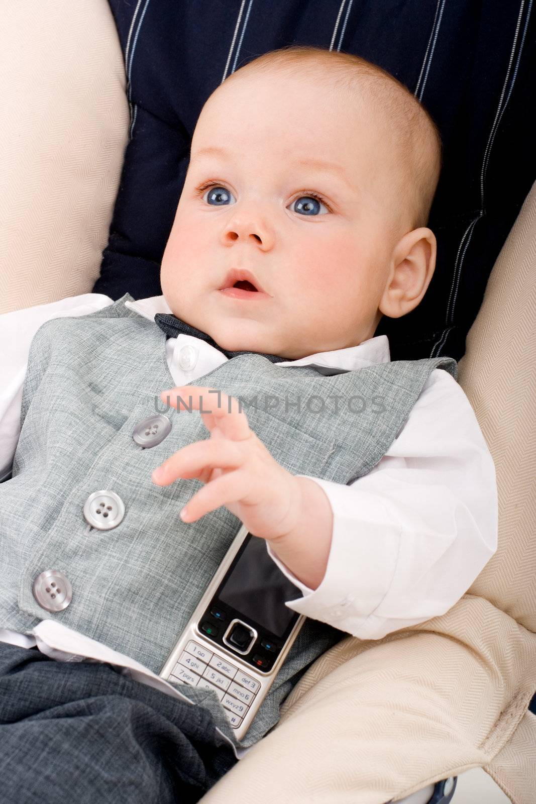 Cute baby with big blue eyes and mobile phone