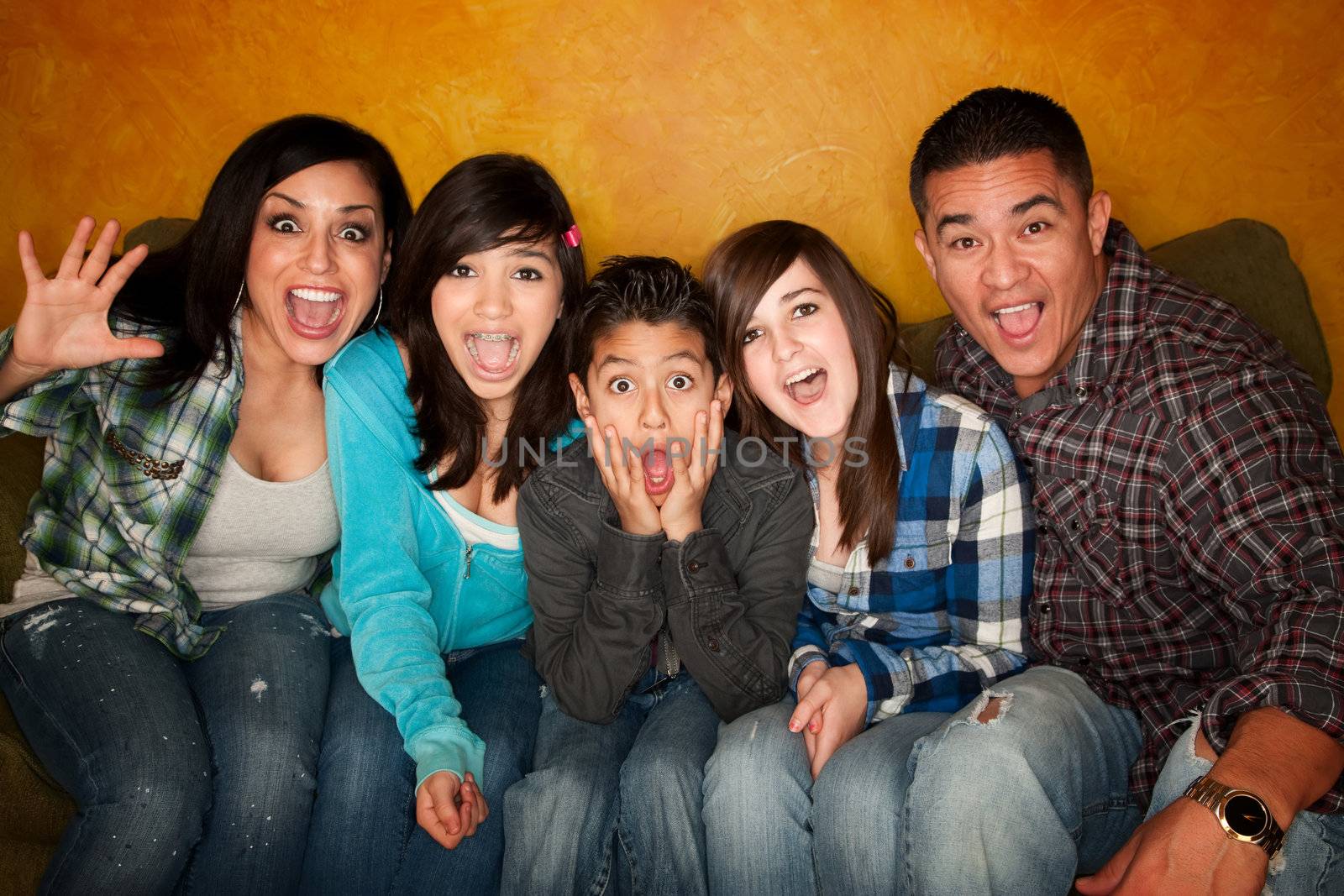 Hispanic Family with Big facial Reactions Sitting on Couch