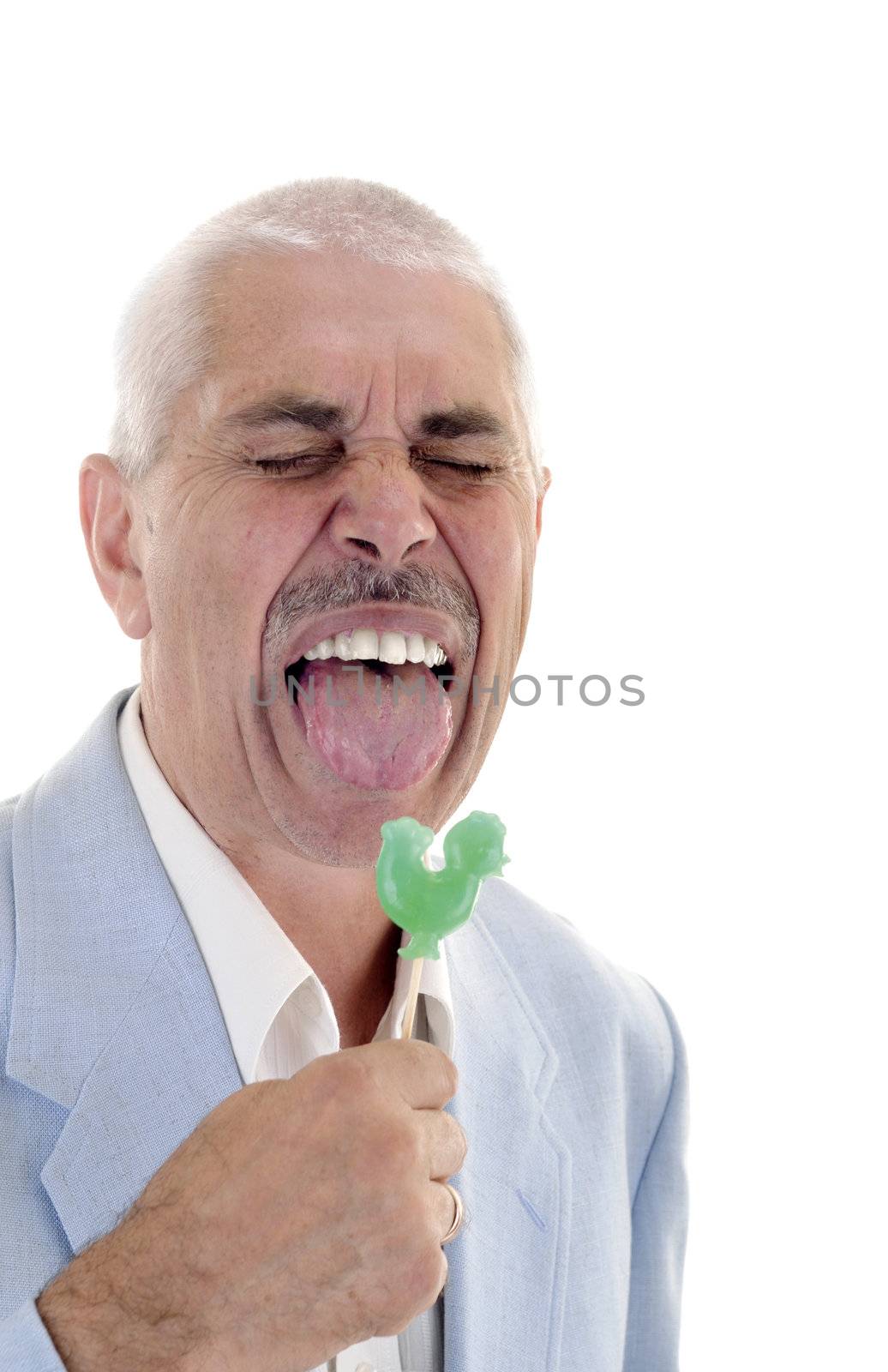Senior man lick the green sweet candy 