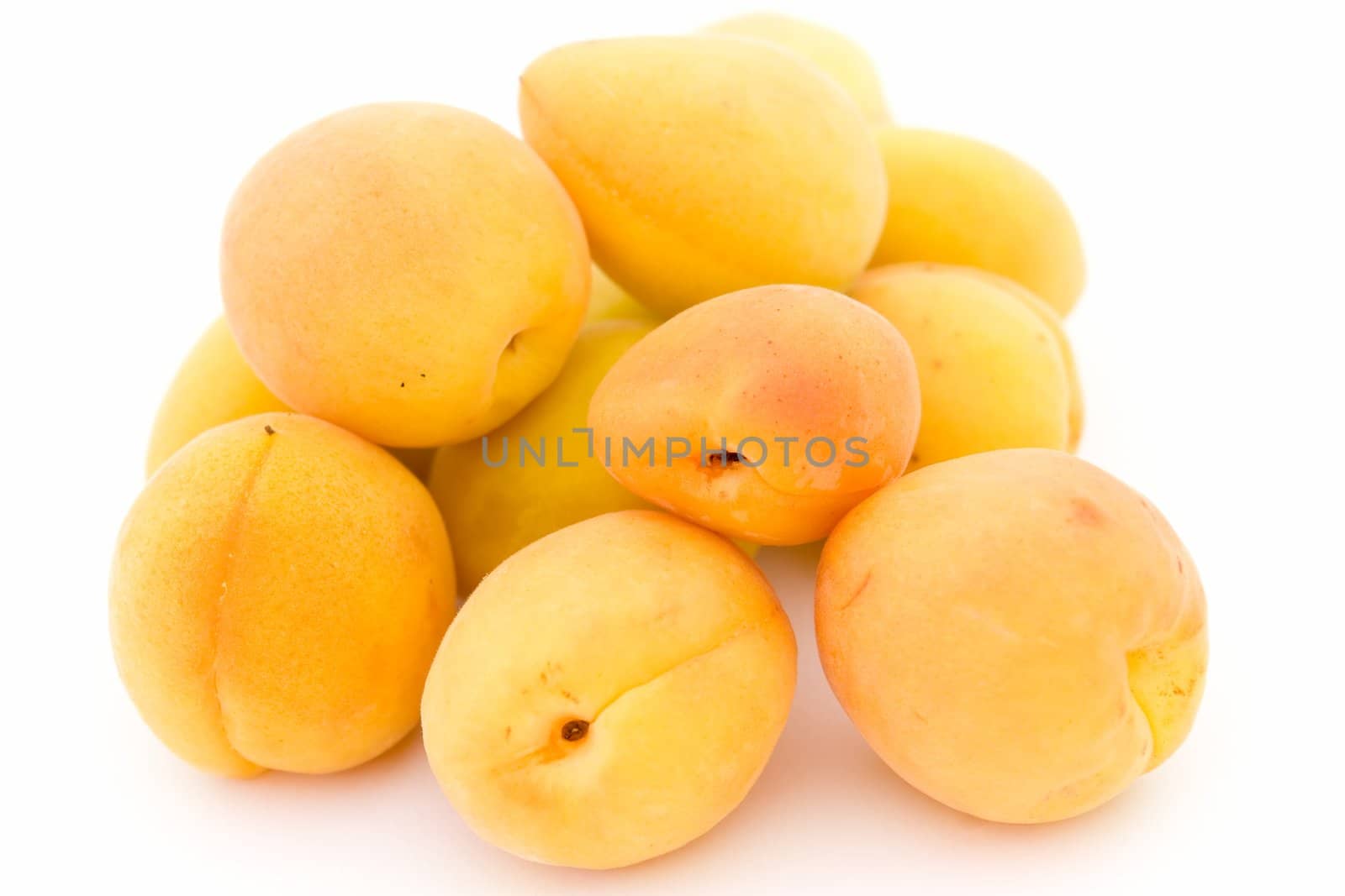 Some ripe apricots on on a white background