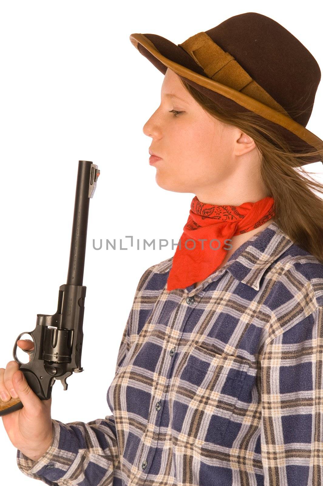 Cowgirl blowing to her gun after shoot (isolated on white)